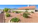 An outdoor backyard featuring gravel, plants, and a grill for outdoor cooking at 5231 E Chasemoor St, Pahrump, NV 89061