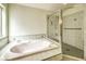 Bright primary bathroom features a soaking tub, shower, and tiled walls at 5231 E Chasemoor St, Pahrump, NV 89061