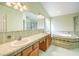 Large bathroom features a double sink vanity, soaking tub, and a separate shower with glass enclosure at 5231 E Chasemoor St, Pahrump, NV 89061