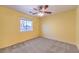 Sunny bedroom with neutral carpeting and large window that provides a natural light at 5231 E Chasemoor St, Pahrump, NV 89061