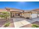 Welcoming home featuring a covered entryway, a two-car garage, and desert-friendly landscaping for easy maintenance at 5231 E Chasemoor St, Pahrump, NV 89061