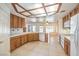 Bright eat-in kitchen with white appliances, natural wood cabinets and a tiled floor for easy maintenance at 5231 E Chasemoor St, Pahrump, NV 89061