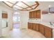 Traditional kitchen offers tiled floor, wood cabinets, and easy access to the laundry room and breakfast nook at 5231 E Chasemoor St, Pahrump, NV 89061
