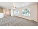 Bright, spacious living room featuring large windows and neutral carpeting at 5231 E Chasemoor St, Pahrump, NV 89061