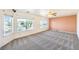 Spacious living area with large windows and stylish carpeting, providing ample natural light and comfortable living at 5231 E Chasemoor St, Pahrump, NV 89061