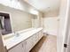 Bright bathroom featuring double sinks, large mirror, tiled floor, and shower-tub combination at 5271 Aurora Beam Ave, Las Vegas, NV 89122