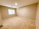 Neutral carpeted bedroom illuminated by a central ceiling light fixture and a bright window at 5271 Aurora Beam Ave, Las Vegas, NV 89122