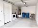 Clean garage with washer, dryer, water heater, storage shelves, and trash bins at 5271 Aurora Beam Ave, Las Vegas, NV 89122
