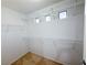 Spacious walk-in closet equipped with multiple shelves and natural light coming in from the windows at 5271 Aurora Beam Ave, Las Vegas, NV 89122