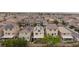 Homes in a neighborhood with solar panels, green trees, and well-maintained yards seen from above at 5409 Holding Ave, Las Vegas, NV 89139