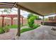 Relaxing backyard with a covered patio, pergola, and lush artificial grass at 5409 Holding Ave, Las Vegas, NV 89139