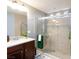 Bathroom boasts a walk-in shower with neutral tile, a vanity with great lighting, and a tiled floor at 5409 Holding Ave, Las Vegas, NV 89139