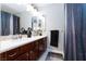 Bathroom featuring double sinks, dark wood cabinets, and stylish decor at 5409 Holding Ave, Las Vegas, NV 89139