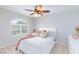 Bright bedroom with large windows, neutral carpet, and a ceiling fan creating a welcoming space at 5409 Holding Ave, Las Vegas, NV 89139