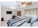 This bedroom features natural light, neutral carpet, and a ceiling fan providing a calming atmosphere at 5409 Holding Ave, Las Vegas, NV 89139
