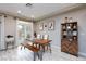 Well-lit dining area features a wooden table with bench seating and sliding glass door access to the backyard at 5409 Holding Ave, Las Vegas, NV 89139