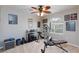 A well-equipped home exercise room with various workout machines and motivational posters on the wall at 5409 Holding Ave, Las Vegas, NV 89139