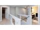 Upstairs hallway with open railing and access to bedrooms and bathrooms at 5409 Holding Ave, Las Vegas, NV 89139