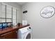 The laundry room is equipped with a washer, dryer, and built-in shelving, combining functionality with modern design at 5409 Holding Ave, Las Vegas, NV 89139