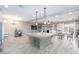 Open living space featuring a kitchen with island seating, dining area, and comfortable living room setup at 5409 Holding Ave, Las Vegas, NV 89139