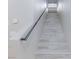 Carpeted staircase with white risers and modern railing leads to the upper level of the home at 5409 Holding Ave, Las Vegas, NV 89139