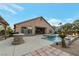 Outdoor living space featuring pool, spa, fire bowls, and backyard grill at 6012 Chessington Ave, Las Vegas, NV 89131