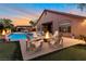 Inviting backyard with a sparkling pool, fire pit, and comfortable seating area for outdoor enjoyment at 6012 Chessington Ave, Las Vegas, NV 89131