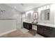 Modern bathroom featuring double vanity sinks, a spacious walk-in shower, and elegant marble tile accents at 6012 Chessington Ave, Las Vegas, NV 89131