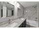 Bright bathroom featuring double sinks, a shower over bath and modern fixtures at 6012 Chessington Ave, Las Vegas, NV 89131