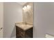 Bathroom featuring a single sink vanity, decorative mirror and modern fixtures at 6012 Chessington Ave, Las Vegas, NV 89131
