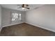 Neutral bedroom featuring a ceiling fan, window, and carpet flooring at 6012 Chessington Ave, Las Vegas, NV 89131