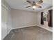 Neutral bedroom featuring a ceiling fan, window, closet and carpet flooring at 6012 Chessington Ave, Las Vegas, NV 89131