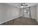 Neutral bedroom featuring a ceiling fan, window, and carpet flooring at 6012 Chessington Ave, Las Vegas, NV 89131