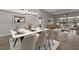 Bright dining area featuring a table with six chairs, modern chandelier, and seamless transition into the living space at 6012 Chessington Ave, Las Vegas, NV 89131