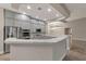 Modern kitchen featuring gray cabinets, stainless steel appliances, a breakfast bar, and easy access to the dining room at 6012 Chessington Ave, Las Vegas, NV 89131