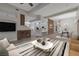 Open-concept living space showcasing a stone accent wall, sleek furnishings, and seamless flow into the kitchen at 6012 Chessington Ave, Las Vegas, NV 89131