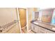 Bathroom showcasing double sinks, granite countertops, and modern towel rack at 6348 Blue Twilight Ct, Las Vegas, NV 89108