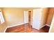 A well-lit bedroom with hardwood floors and a view of the interior hallway at 6348 Blue Twilight Ct, Las Vegas, NV 89108