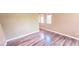 Bright bedroom with wood-look flooring and multiple windows at 6348 Blue Twilight Ct, Las Vegas, NV 89108
