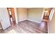 Spacious bedroom with wood-look floors leading to an attached bathroom and closet at 6348 Blue Twilight Ct, Las Vegas, NV 89108