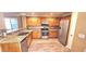 Modern kitchen featuring wood cabinets, granite counters, and stainless steel appliances at 6348 Blue Twilight Ct, Las Vegas, NV 89108