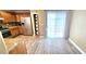 Well-lit kitchen with stainless steel appliances, granite countertops, and wood-look flooring at 6348 Blue Twilight Ct, Las Vegas, NV 89108
