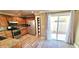 Well-lit kitchen boasts stainless steel appliances, wood cabinets, granite countertops, and wood flooring at 6348 Blue Twilight Ct, Las Vegas, NV 89108