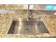 Stainless steel kitchen sink with granite countertop and decorative tile backsplash at 6348 Blue Twilight Ct, Las Vegas, NV 89108