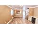 Open concept living room with wood floors, open stairway and dry bar at 6348 Blue Twilight Ct, Las Vegas, NV 89108