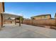 Spacious backyard with concrete patio, brick wall, landscaping, and covered area at 7216 Campolina Ct, Las Vegas, NV 89113
