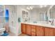 Bathroom featuring double sinks with wood cabinets, a shower, and a toilet at 7216 Campolina Ct, Las Vegas, NV 89113