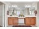 Bathroom with a double sink vanity, ample storage, and contemporary lighting at 7216 Campolina Ct, Las Vegas, NV 89113