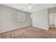 Bedroom featuring plush carpet, window with blinds, base molding, and a ceiling fan at 7216 Campolina Ct, Las Vegas, NV 89113