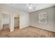 Bright bedroom features neutral walls, plush carpeting, ceiling fan, and walk-in closet at 7216 Campolina Ct, Las Vegas, NV 89113
